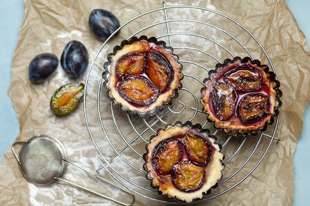 Baking with plums on the parchment. Confectionery productの写真素材