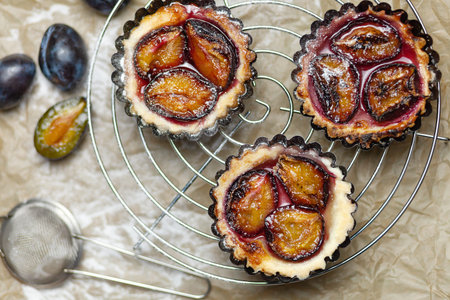 Baking with plums on the parchment. Confectionery productの写真素材