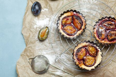 Tarts plums on the parchment. Homemade cake. Confectionery productの写真素材
