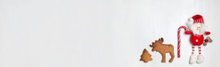 Christmas banner with cookies and Christmas toy or attribute on a white wooden backgroundの写真素材