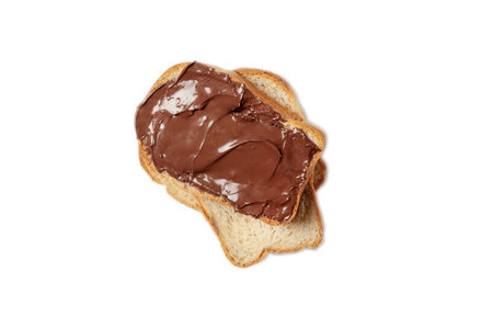 Slice of toast with chocolate hazelnut spread on isolated background. Toasted piece of bread,...