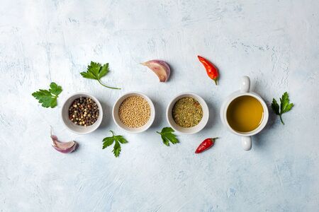 Set of fragrant spices. Pepper, mustard seeds, herbs on a concrete blue backgroundの写真素材
