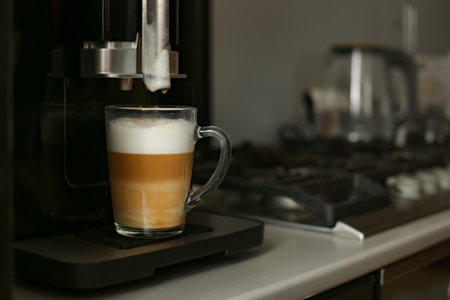 The finished coffee has three layers of white, beige and brown. Layering. Coffee with milk.の写真素材