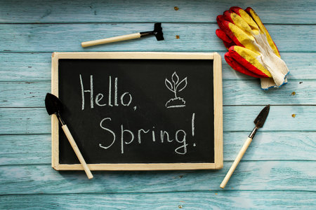 Hello Spring. Spring composition background, wallpaper. Planting equipment, preparation. Tools and gloves.の写真素材