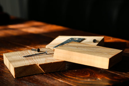 a bit for a screwdriver and a few self-tapping screws lie on a piece of wood. close-up.の写真素材