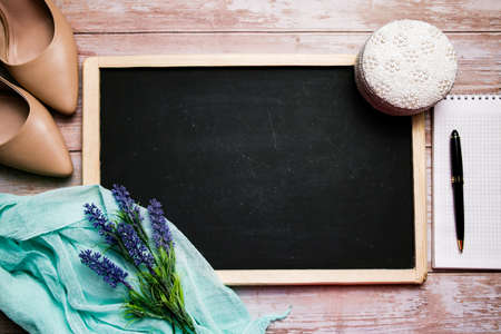 Womens beige shoes, jewelry box, notebook and pen and chalk board with free space for text. Delicate composition of feminine items.の写真素材