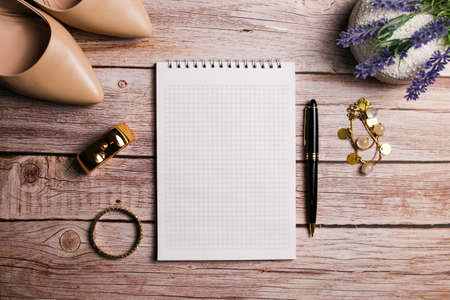 Beige fashionable womens accessories from the blogger. Heels, perfume and bracelet, jewelry. Blank center, space for your own text, space for copy.の写真素材