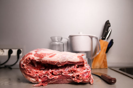 Raw red pork tenderloin with ribs, tenderloin on the interior of the kitchen.の写真素材