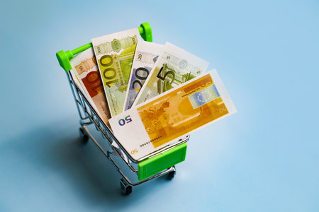 Euro banknotes in a trolley, money in a consumer basket, a supermarket trolley.の写真素材