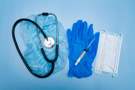 stethoscope, gloves and medical mask, injections on a blue background