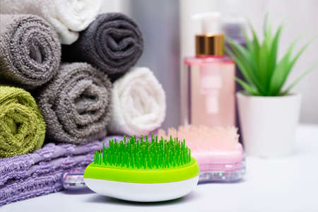 A set of combs and hair brushes, bath accessories, a set of various bath towels.の写真素材