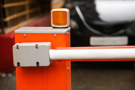 Red and white closed barrier, restriction for the entry of cars.の写真素材