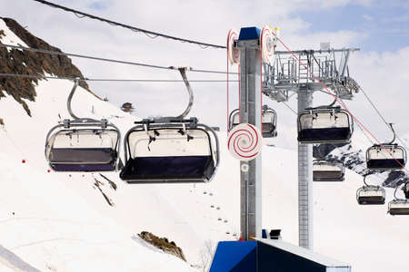 Open air ski lift going to the top of the mountain for alpine skiing.の写真素材
