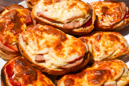Fried sandwich in the oven, cheese and sausage on a piece of loafの写真素材