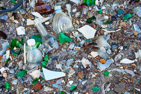 Rubbish dump broken glass, plastic and bottles, recycle materials.