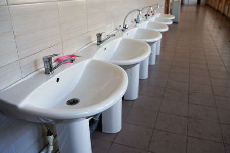 Close-up Of Washbasins In Row in public placeの写真素材