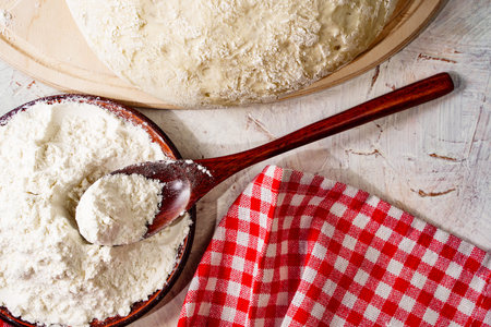White wheat cooking flour close up in spoon, home cooking baking background