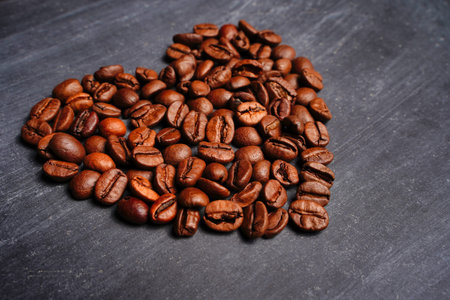 Coffee beans shaped as a heart. We love coffee background