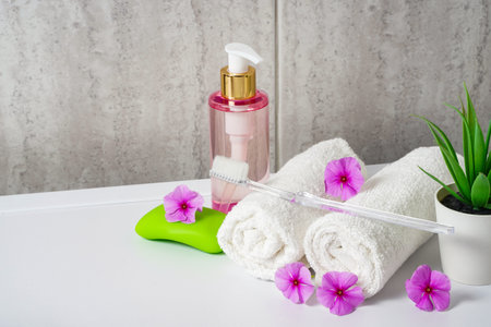 Toothbrushes, soap and two towels. Rose flowers aromatherapy home