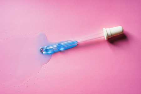 Liquid cool blue gel or serum on pink background