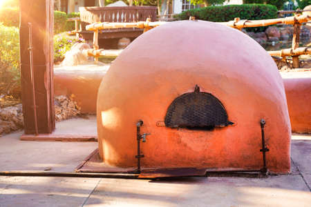 Clay red stove in the yard, powered by natural gas. Pizza ovenの写真素材