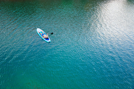 Paddleboard SUP Man having fun paddle board in Hawaii. Fitness recreational leisure activity. Beach...