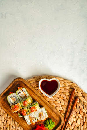 Sushi rolls covered cucumber with fresh fish and copy space for text.の写真素材