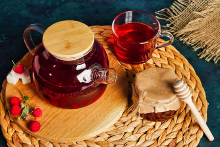 Honey, berry tea and honeysuckle on rustic blue backgroundの写真素材