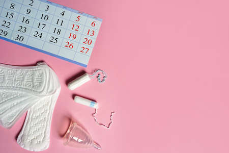 Menstrual calendar, sanitary pad, tampons and napkin. Control of the regular cycle in women.の写真素材