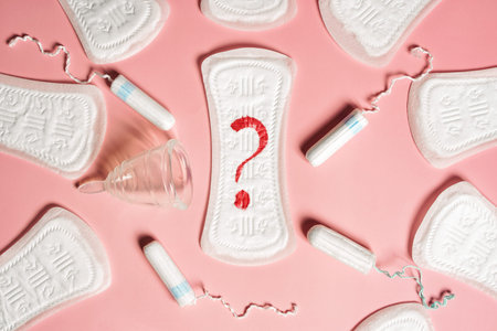 Pad, menstrual cup, tampon on a pink background. The view is flat. Concept of critical days,...