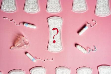 Pad, menstrual cup, tampon on a pink background. The view is flat. Concept of critical days,...