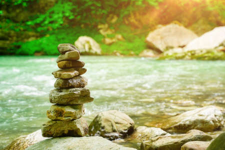 Pyramid of zen pebble stones, meditation, harmony and balance concept. Waves in backgroundの写真素材