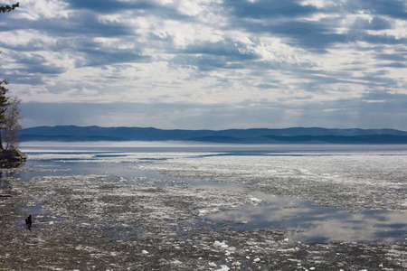 Beautiful mountain lake, blue sky with clouds. Mountain lake Turgoyak spring in the Urals.の写真素材