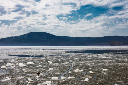 Beautiful mountain lake, blue sky with clouds. Mountain lake Turgoyak spring in the Urals.の写真素材