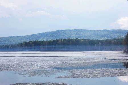 Beautiful mountain lake, blue sky with clouds. Mountain lake Turgoyak spring in the Urals.の写真素材