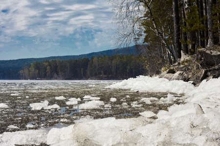 Beautiful mountain lake, blue sky with clouds. Mountain lake Turgoyak spring in the Urals.の写真素材