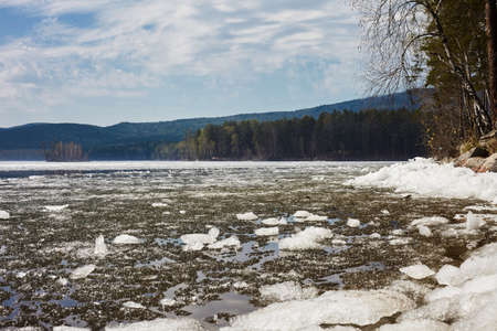 Beautiful mountain lake, blue sky with clouds. Mountain lake Turgoyak spring in the Urals.の写真素材