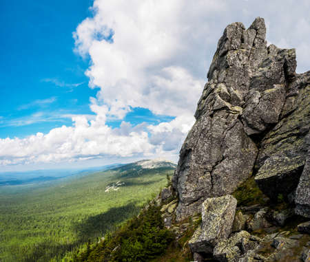 Fantastic view from mountain top on forest valley and mountains with blue sky. Dramatic picturesque scene. Beauty world.の写真素材