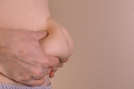 The Dangers of Belly Fat. Obese Man in Jeans Squeeze the Belly Fat. man with a big belly and more...