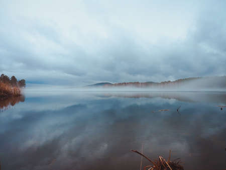 spring landscape. recently melted ice on the lake, fog and heavy clouds.の写真素材