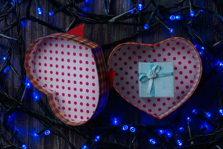 garland and Christmas gift on background of wooden boardsの写真素材