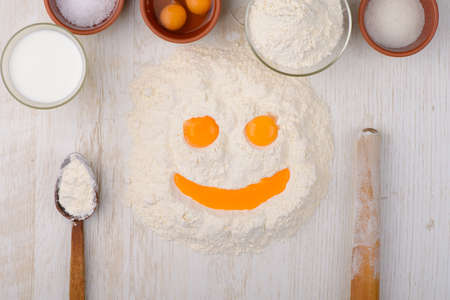 flour, eggs, milk, salt, sugar baking ingredients on a tableの写真素材