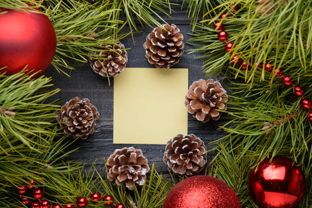 Christmas background with fir branches,pine cones on the old wooden boardの写真素材