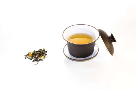 snuff cup with green, flower tea, gaivan and a tea cup on a white background ??の写真素材
