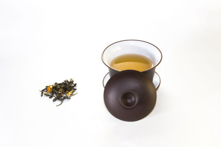 snuff cup with green, flower tea, gaivan and a tea cup on a white background ??の写真素材