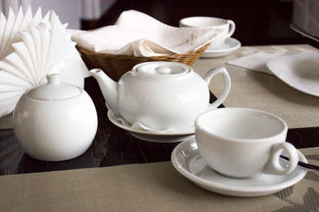 White tea set on the table in the restaurantの写真素材