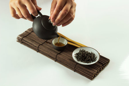 girl pours tea during chinese tea ceremony