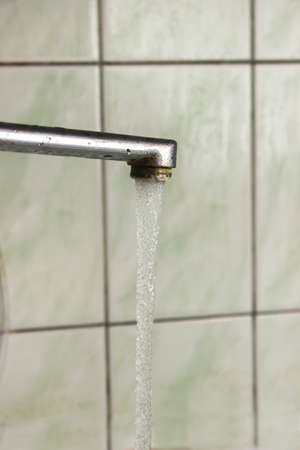 water from the old faucetの写真素材