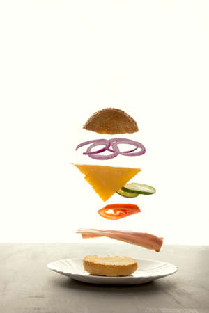 Sandwich floating in the air on a white background. The sandwich rises behind the power of levitation.の写真素材