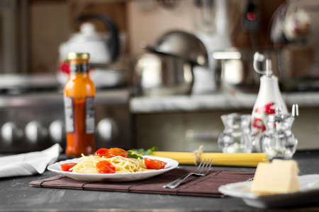 Spaghetti pasta in tomato sauce with cheese and parsley. Italian spaghetti pasta over dark stone background.の写真素材